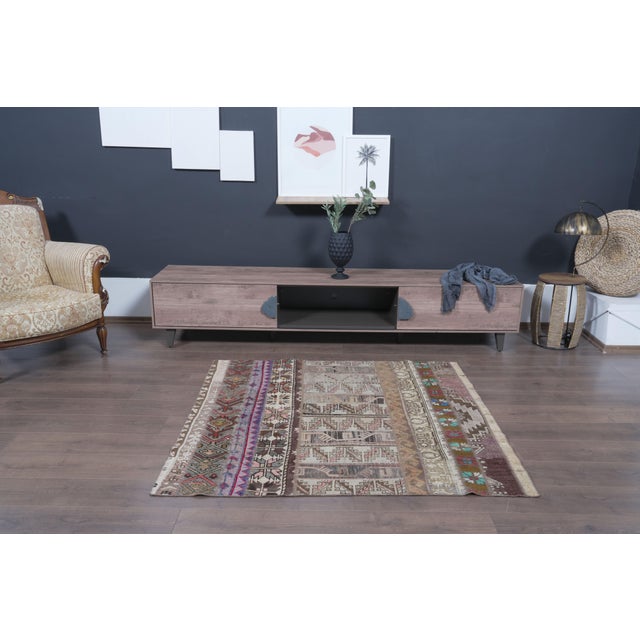 Bring authentic charm and bohemian elegance to your space with this one-of-a-kind vintage Anatolian patchwork kilim...