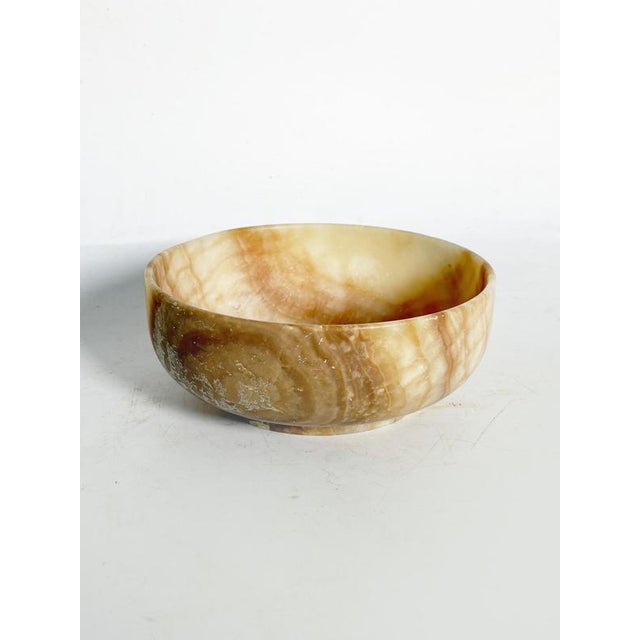 Onyx bowl, France, 1950s, an elegant decorative piece carved from a natural stone with warm, translucent hues. This bowl...