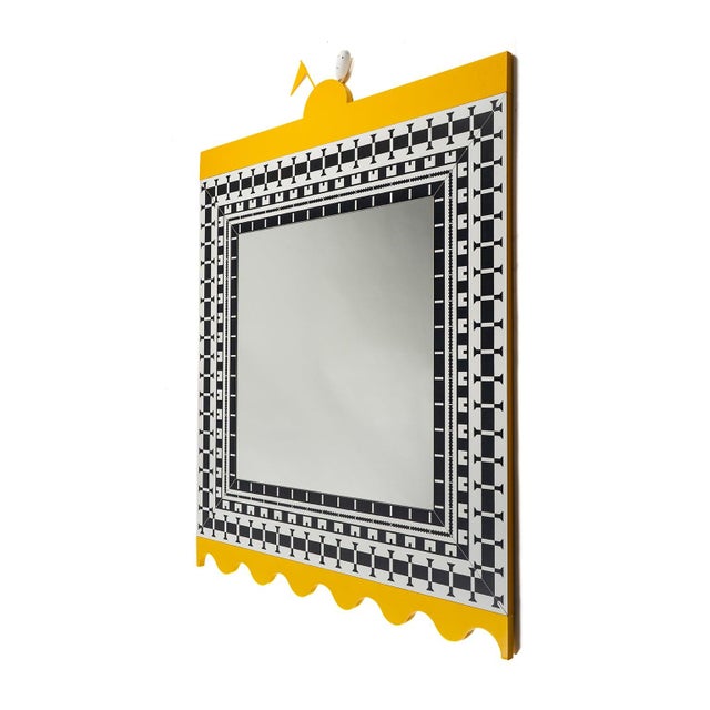 A wide black and white checkered frame, bordered all around by a yellow crenellation that extends beyond the surface, and...