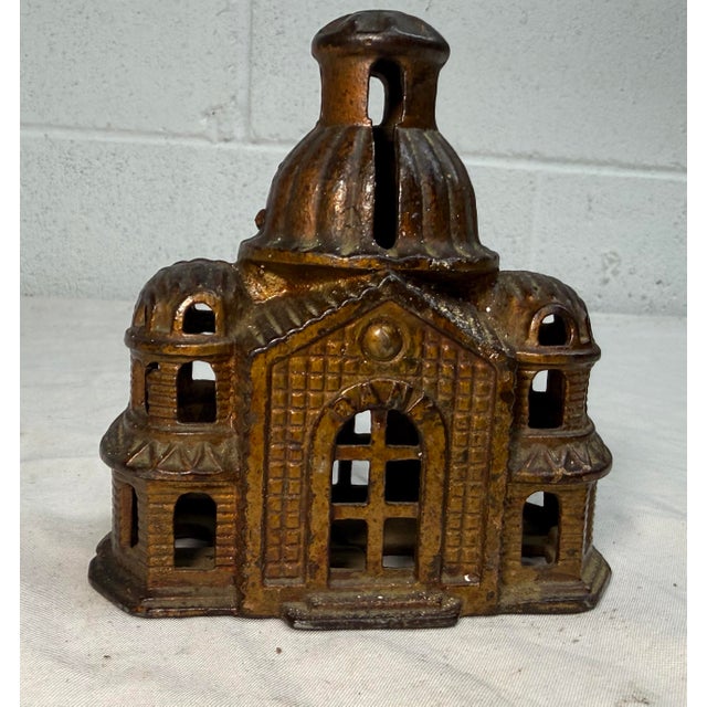 The product is an antique A. C. Williams domed mosque palace still coin bank with original paint, made of cast iron in the...