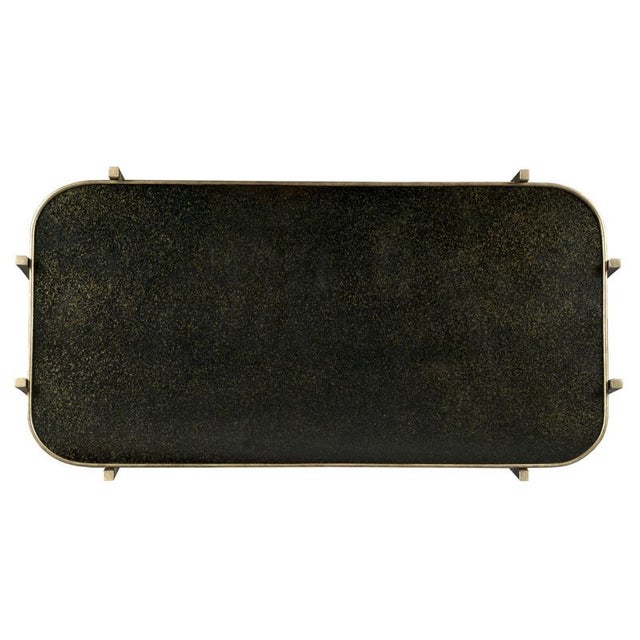 Graceful tapering metal legs support a rectangular mirrored galleried top. Crafted from forged steel.