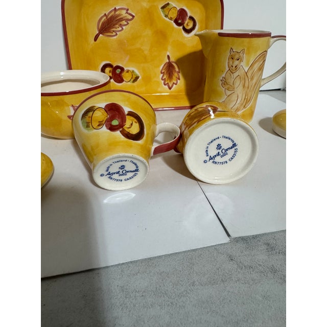 This is an April Cornell “Squirrel Fall Leaves” 7 Piece Ceramic Tea Set consisting of a Tea pot with lid, tea cup, creamer...