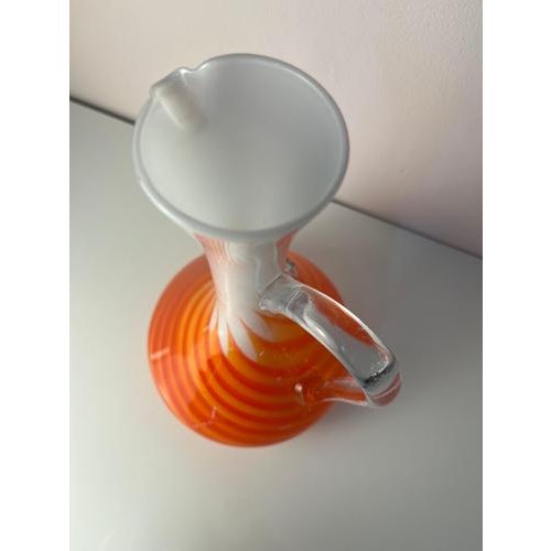 This opal glass vase with a handle is a captivating masterpiece of 1970s Italian glass art. Shaped like a slender carafe,...