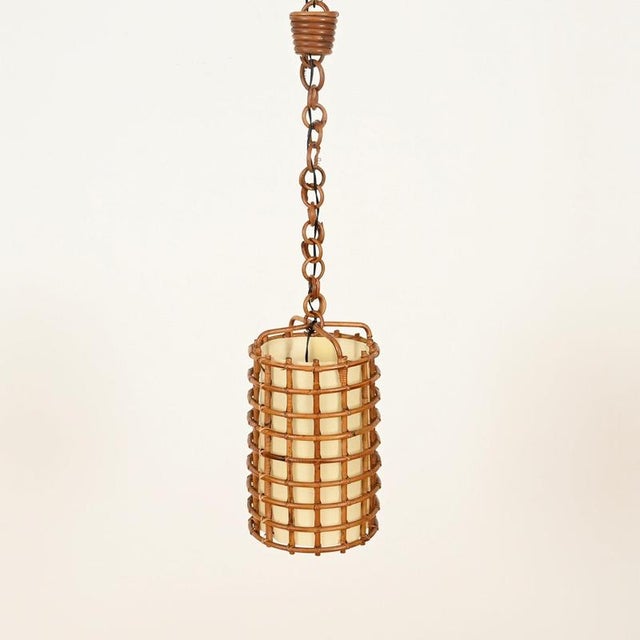Marvelous and unique mid-century organic pendant entirely hand-crafted in curved rattan and hand-woven wicker, completed...