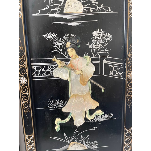 This vintage set of 3 Asian black lacquer panels featuring geishas with raised mother of pearl details is a unique and...
