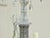 A French four-light chandelier from circa 1920 with curving arms, faceted crystals and beaded strands. This exquisite...
