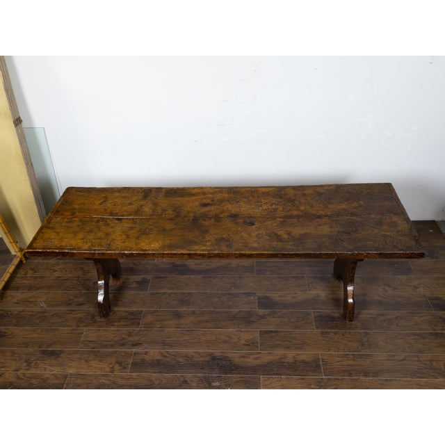 An Italian walnut farm table circa 1800 with carved legs, plain cross stretcher and nicely aged patina. This Italian...