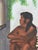 This is a 1970s nude portrait of a Mexican woman sitting on stairs. The painting is set in a gold wood frame. Vivid colors...