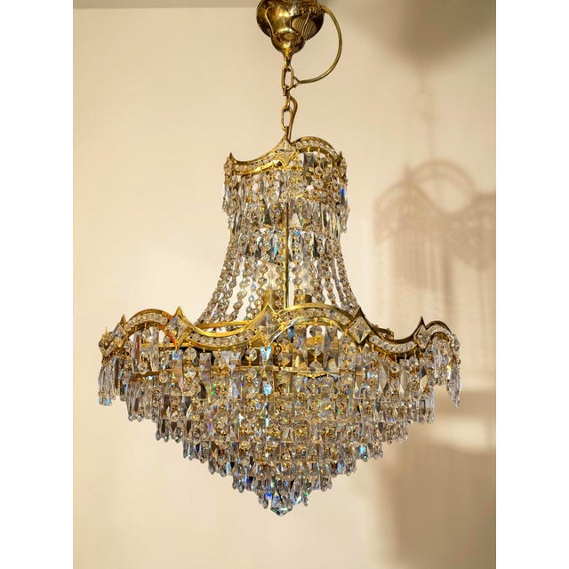 Pair of Monumental Hollywood Regency Crystal Chandeliers, Italy, circa 1965–1975 An exceptional and highly decorative pair...