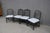 Set of four Hollywood Regency style dining side chairs featuring ebonized faux bamboo frames with decorative lattice...