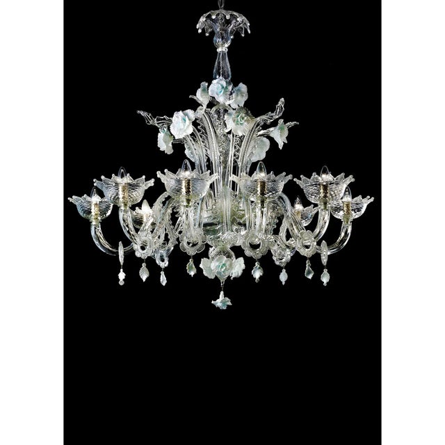 Venetian floreal Murano glass chandelier with leaves and flowers pinched by hand full of precious white details. That give...