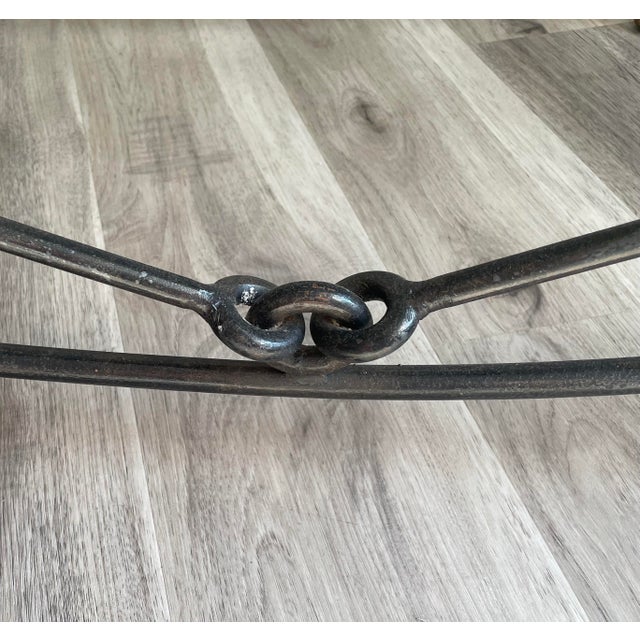 A magnificent and cohesive 5-piece estate suite of handcrafted brutalist wrought iron tables, designed in the iconic...