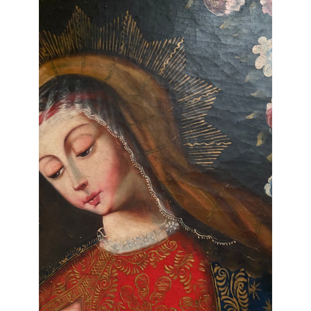 A beautiful antique religious oil painting depicting the Madonna and Child in a traditional devotional composition...