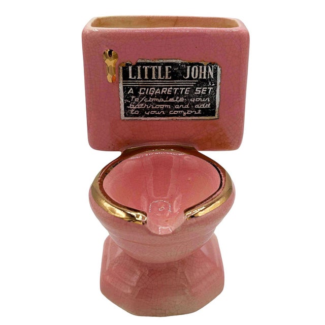 1950s Ceramic "Little John" Toilet Ashtray Cigarette Holder by Artmark featuring a pink finish with gold-tone accents. A...