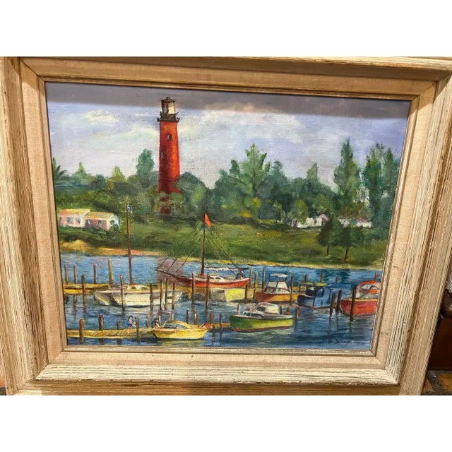 Mid-20th century painting of a lighthouse in a harbor. Colorful, happy composition of colors. Signed Vera Bettinger? Solid...