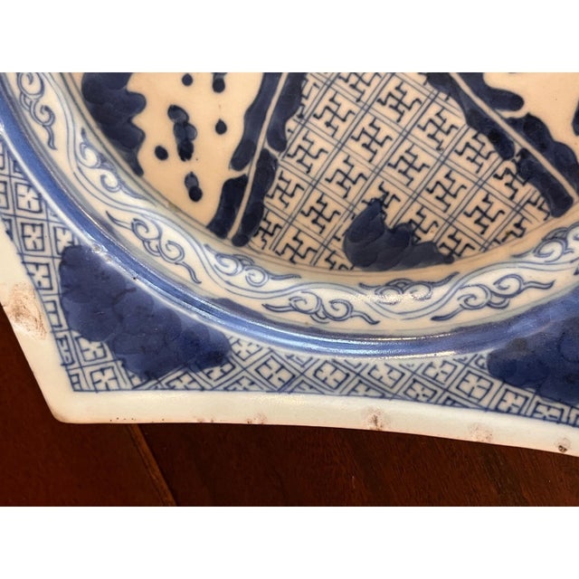 An intriguing antique Chinese blue and white porcelain dish featuring a striking hexagonal form with bracketed rims. The...