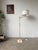 Floor lamp from the 80s with its ivory lacquer base and brass-plated metal details. The top has a double articulated brass...