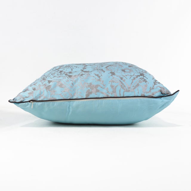 Add a touch of elegance to your living space with this vintage-inspired pillow featuring a delicate blue and gray damask...