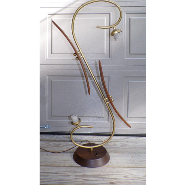 Vintage Mid Century Modern Brass + Walnut Table Lamp c. 1960's The lamp features a sculptural design with 2 curved walnut...