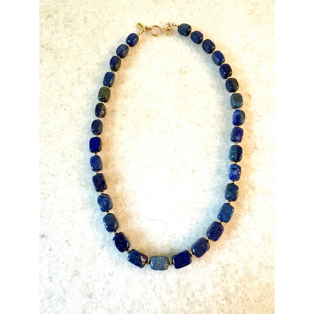 Gorgeous lapis beaded necklace with gold tone spacers and clap. Designed by Matthew Izzo