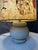 Elegant vintage lamp featuring a rounded gray ceramic base and a large fabric shade reproducing The Kiss, Gustav Klimt's...