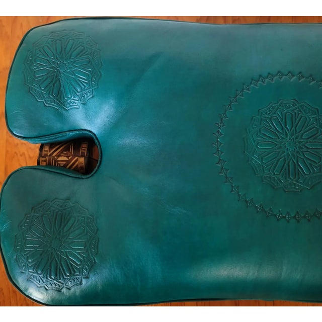 Handmade Moroccan camel saddle with genuine leather cushion and carved cedar wood base, measuring approximately 24 inches...