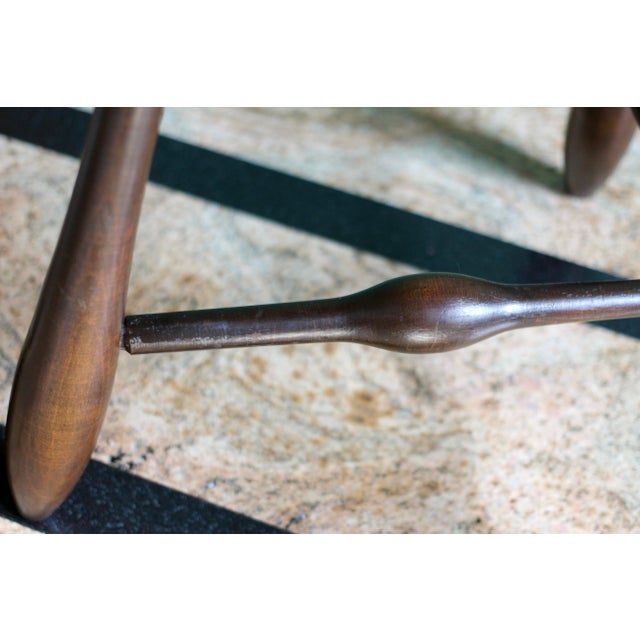 An amazing dark stained maple stool with tripod legs and curved embellishments. Modified oval or egg shaped seat for...