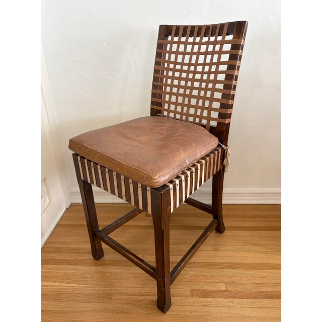 Beautifully crafted vintage counter stool featuring a open woven leather lattice strap design on seat and back rest....