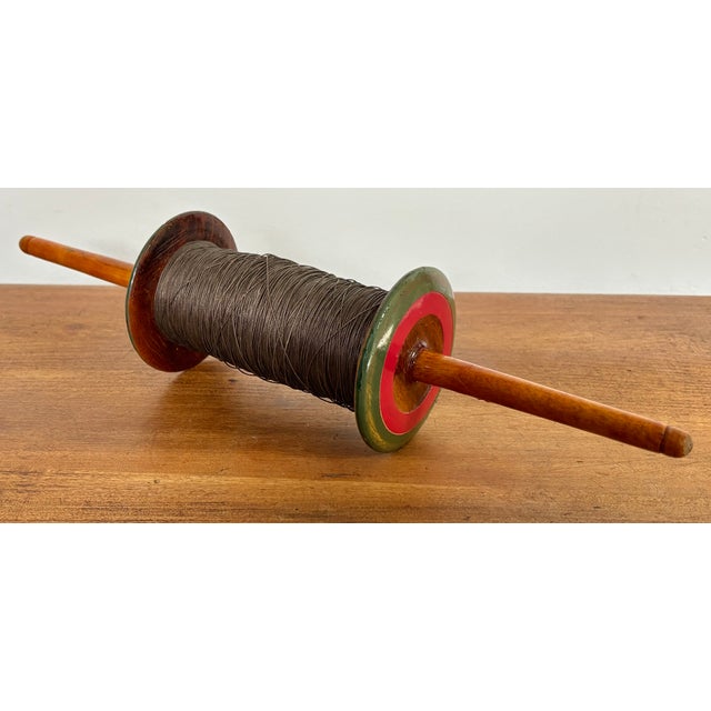 Vintage turned wood spool with brown kite string. Most items found at Pub & Oasis are vintage and antique in nature which...