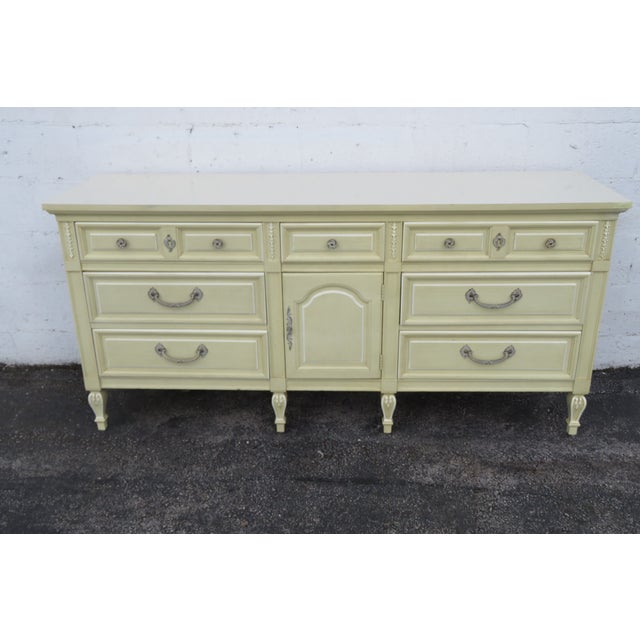 This classic Dresser is made out of wood, laminated, and metal. This Dresser was made by Dixie Furniture in the lovely...