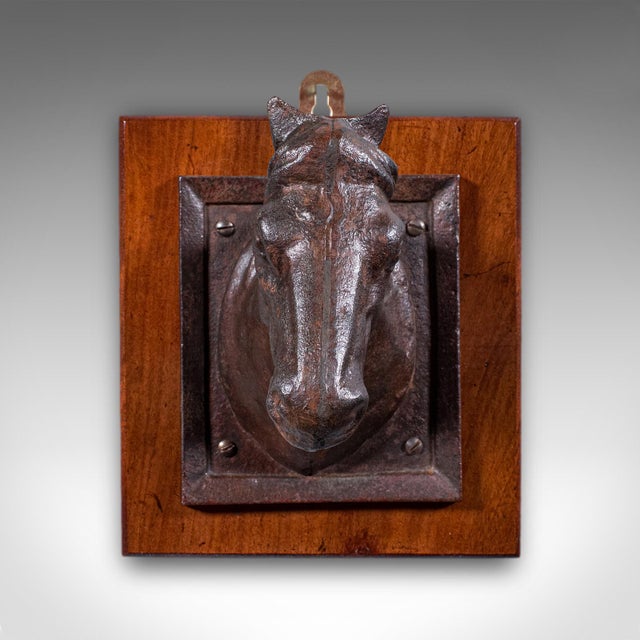 This is an antique mounted horse bust. An English, cast iron and mahogany coat, crop or helmet tack hook, dating to the...