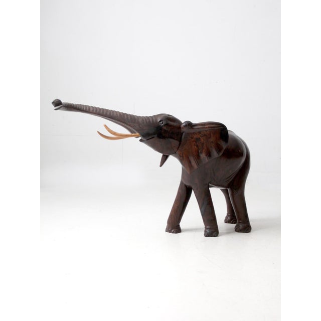 This large ironwood elephant sculpture is defined by strong proportion, smooth carving, and a commanding sense of scale....