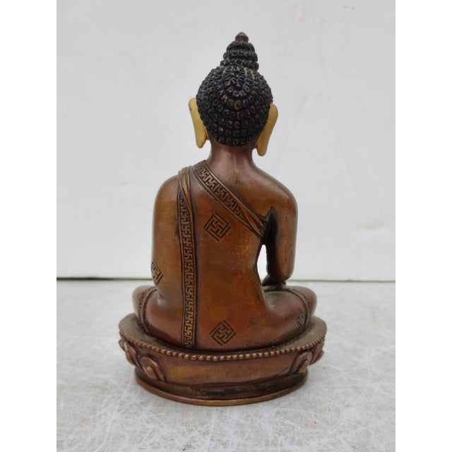 Bronze Buddha with polychrome face, Classic seated Buddha with an alms bowl, and touching the earth. Late 20th century,...