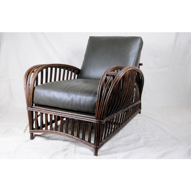 Chair and ottoman leather upholstery wicker (2 pieces). Cushions have been re-upholstered in a soft green Edelman luxury...