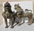 Nepalese cast bronze pair of male and female temple guardians. Beautifully detailed curls of the manes, feet, tails, and...