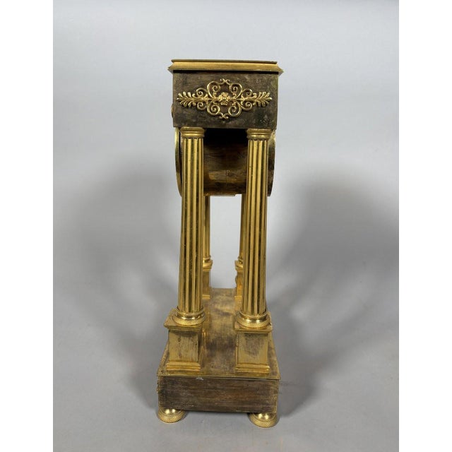 Empire period portico clock, French work, circa 1800. The clock is in the form of a portico framed by four antique-style...