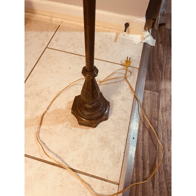 What a stunning piece of fashionable history! This 38” tall table lamp is brass styled cast- metal stem on a weighted...