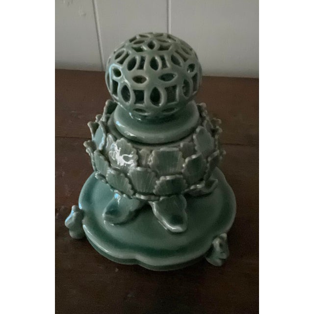 It is Korean blue celadon style incense burner. The body is wrapped with lotus leaves design which signifies mountain...