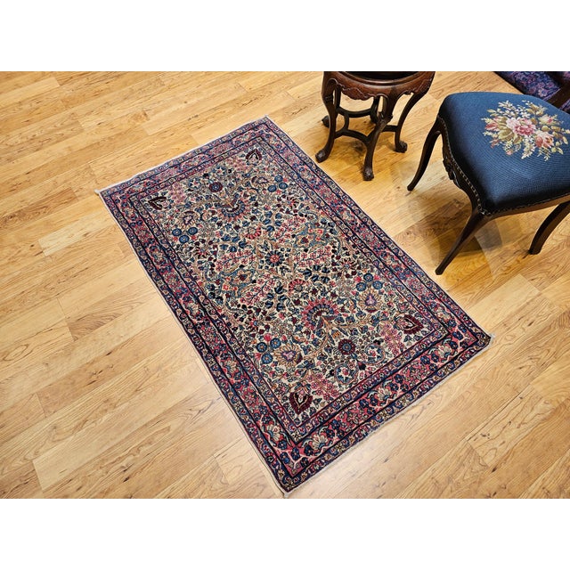 3’ x 4’ 9” An astonishingly beautiful and colorful Persian Kerman Lavar area rug in floral design in ivory background with...