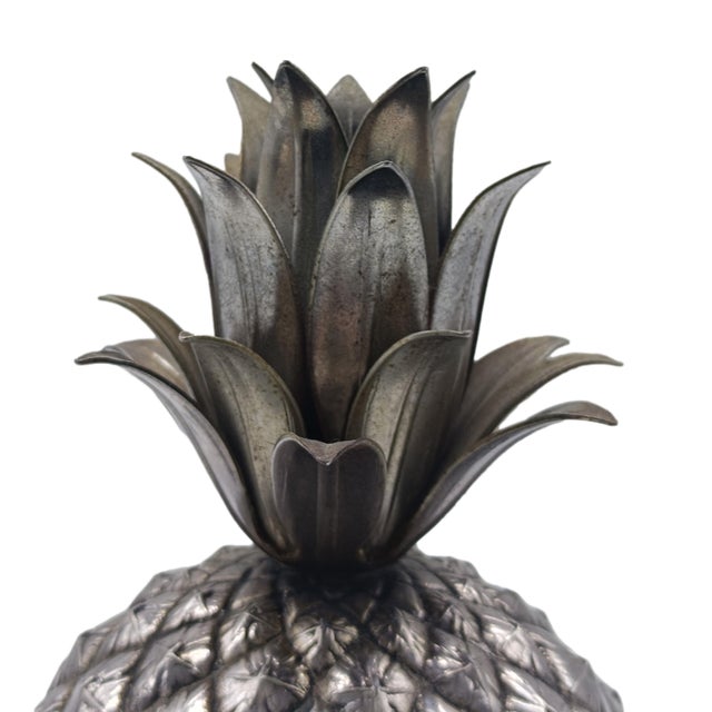 A pineapple-shaped ice bucket in silver-plated pewter, designed by Mauro Manetti for the Fonderia D’Arte in Florence. It...