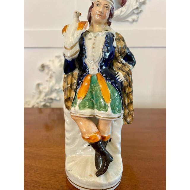 Antique Victorian Staffordshire flatback figure of a gentleman in Scottish period dress with a hawk perched on his...