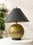 A distinctive vintage table lamp combining a dramatically oversized black tapered shade with an expressive sculptural...