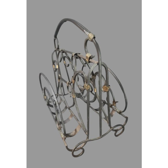 Add a touch of vintage charm to your home with this beautiful wrought iron and brass magazine holder rack. The ornate...