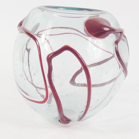 A 1988 hand-blown art glass vase, signed on the bottom by Lewis Haynes. The sculptural, transparent orb form is accented...