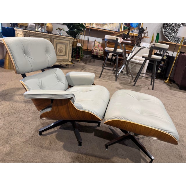 Experience the pinnacle of mid-century modern design with this iconic Eames Lounge Chair and Ottoman by Charles and Ray...