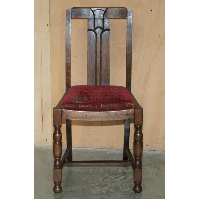 This lovely circa 1930's Art Deco English oak hall chair with Latin inscribed upholstery. Dimensions Height:- 88.5cm, seat...