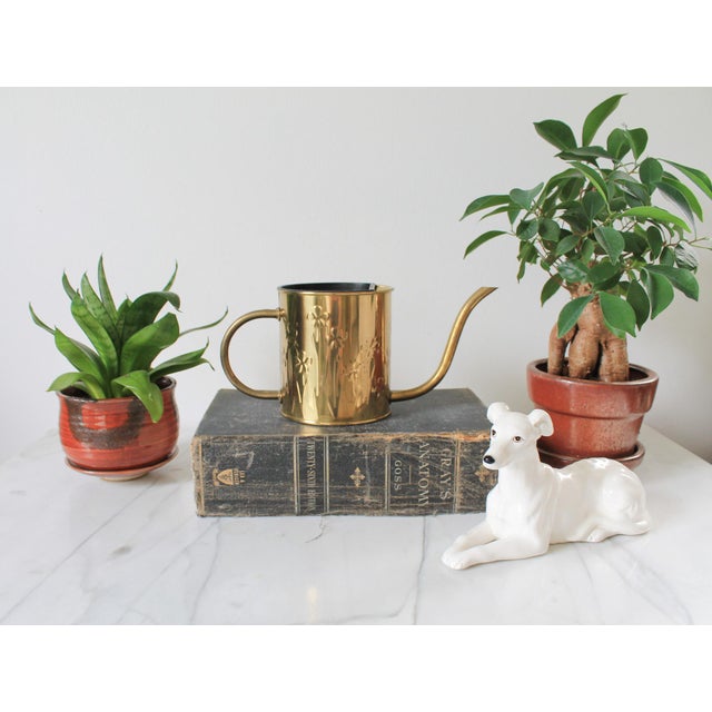 Vintage brass watering can featuring an embossed floral pattern, made in Holland by Nijhof-Zevenaar. Dated 1986. Makers...