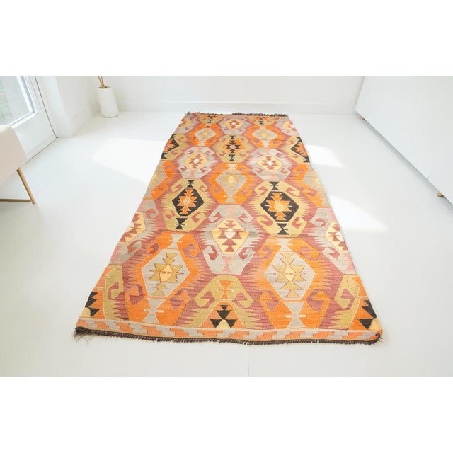 This is a vintage Turkish Oushak rug from the Mid 20th Century. The piece was hand-knotted.
