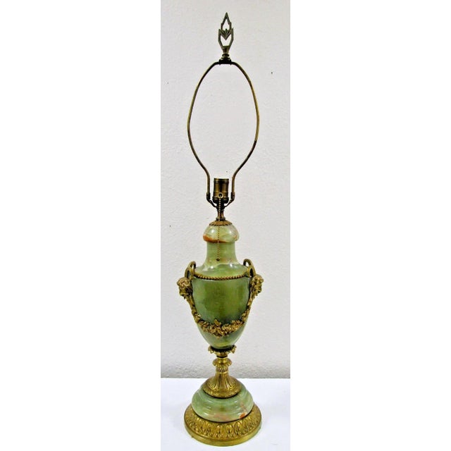 The Antique French Neoclassical Green Onyx Table Lamp features a beautiful marbled pattern with intricate gilt bronze...