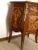 Chest of drawers inlaid in briar, cherry, olive and ebony wood, the result of high Italian craftsmanship. Details in...